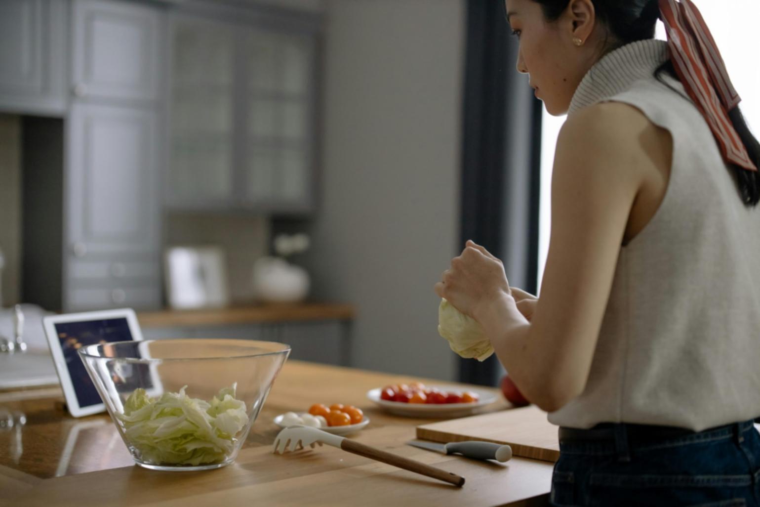 Culinary student practicing advanced plating techniques during hands-on training session
